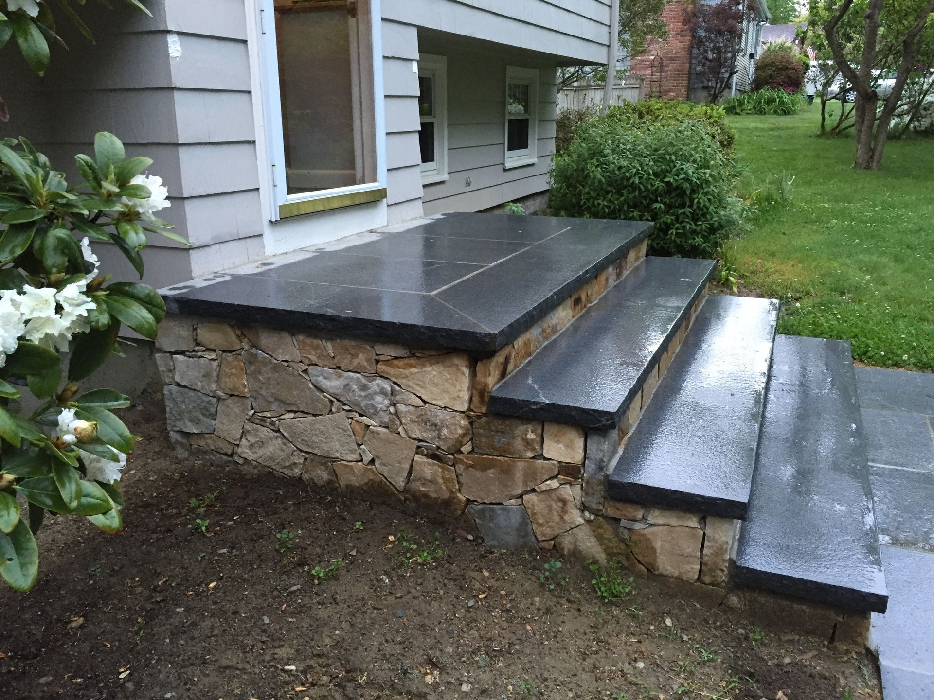 A stone porch with stairs leading up to it
