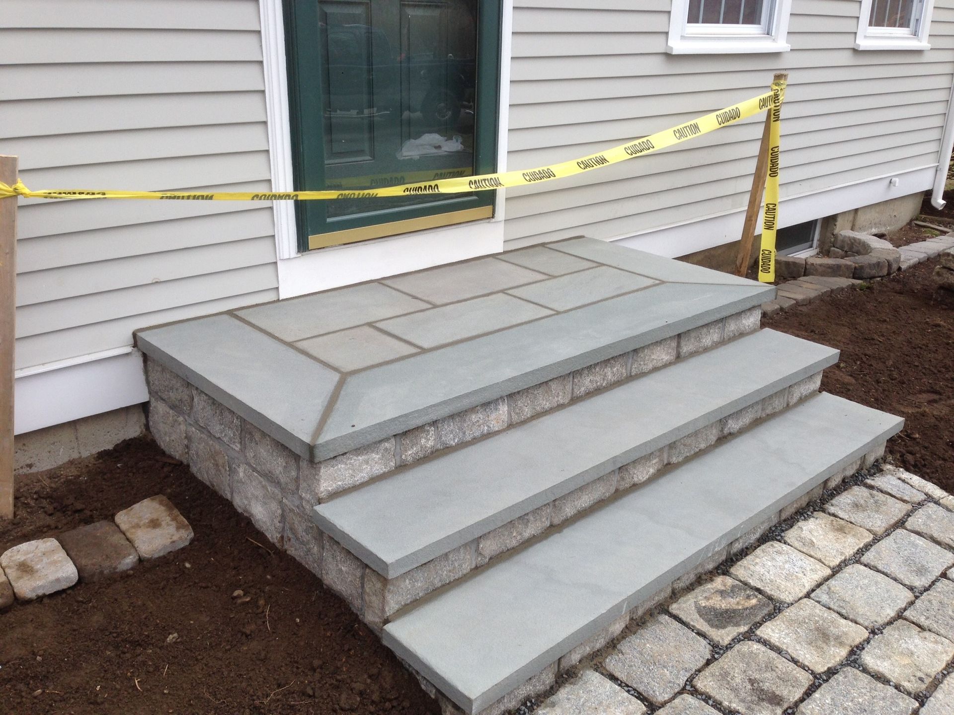 A set of steps leading up to a house with yellow tape around it