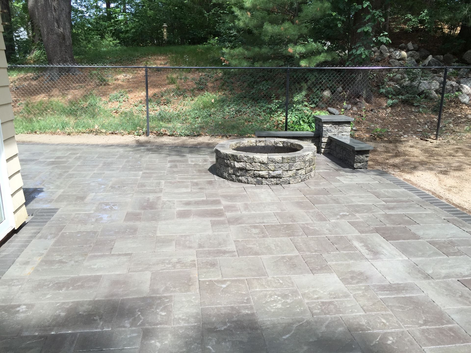 There is a fire pit in the middle of the patio.