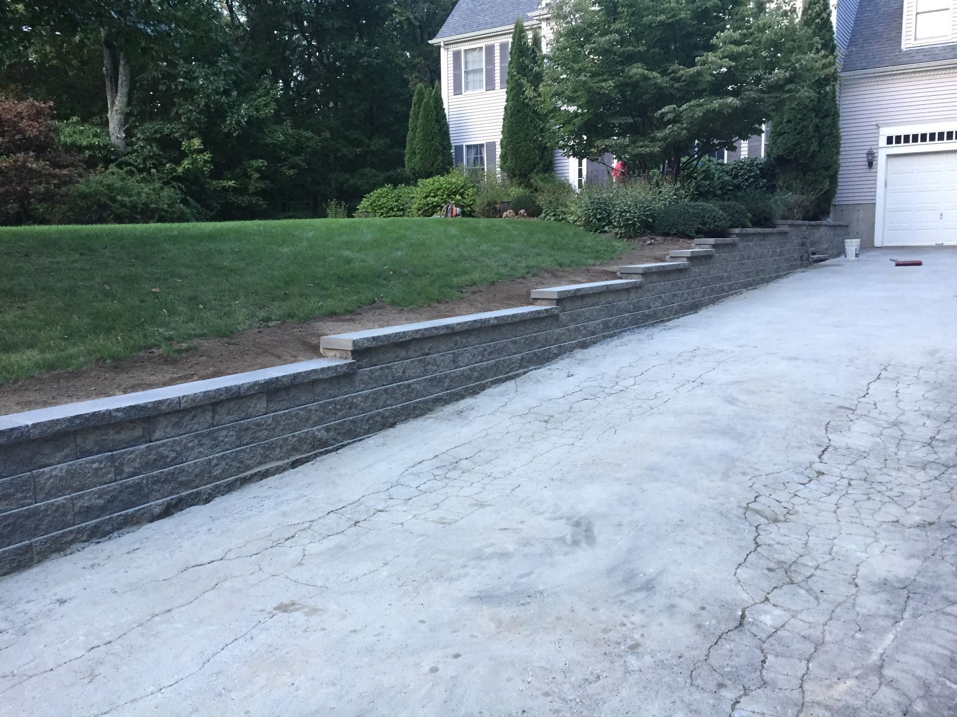 A driveway leading to a house with a garage door