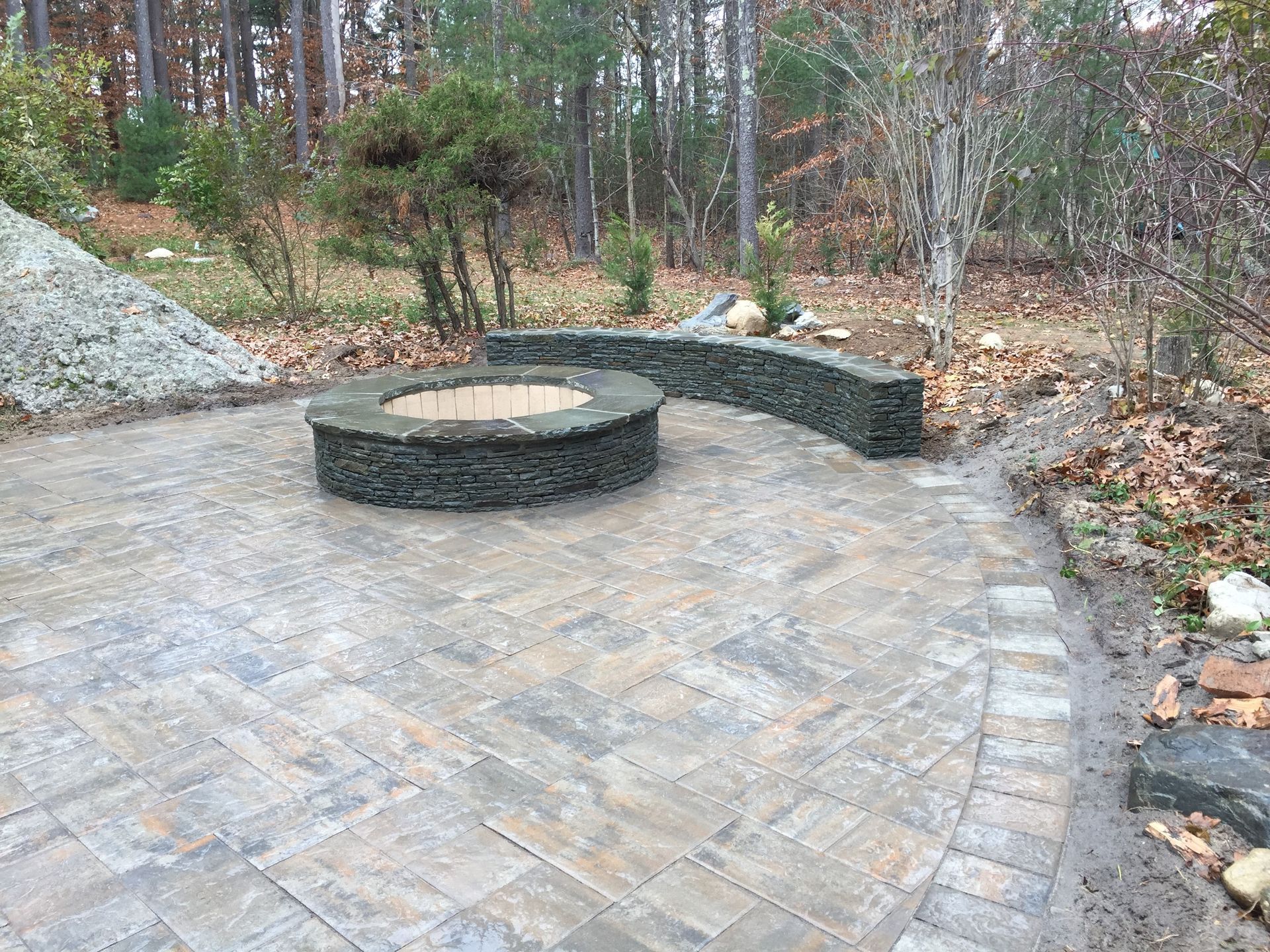 There is a fire pit in the middle of the patio.