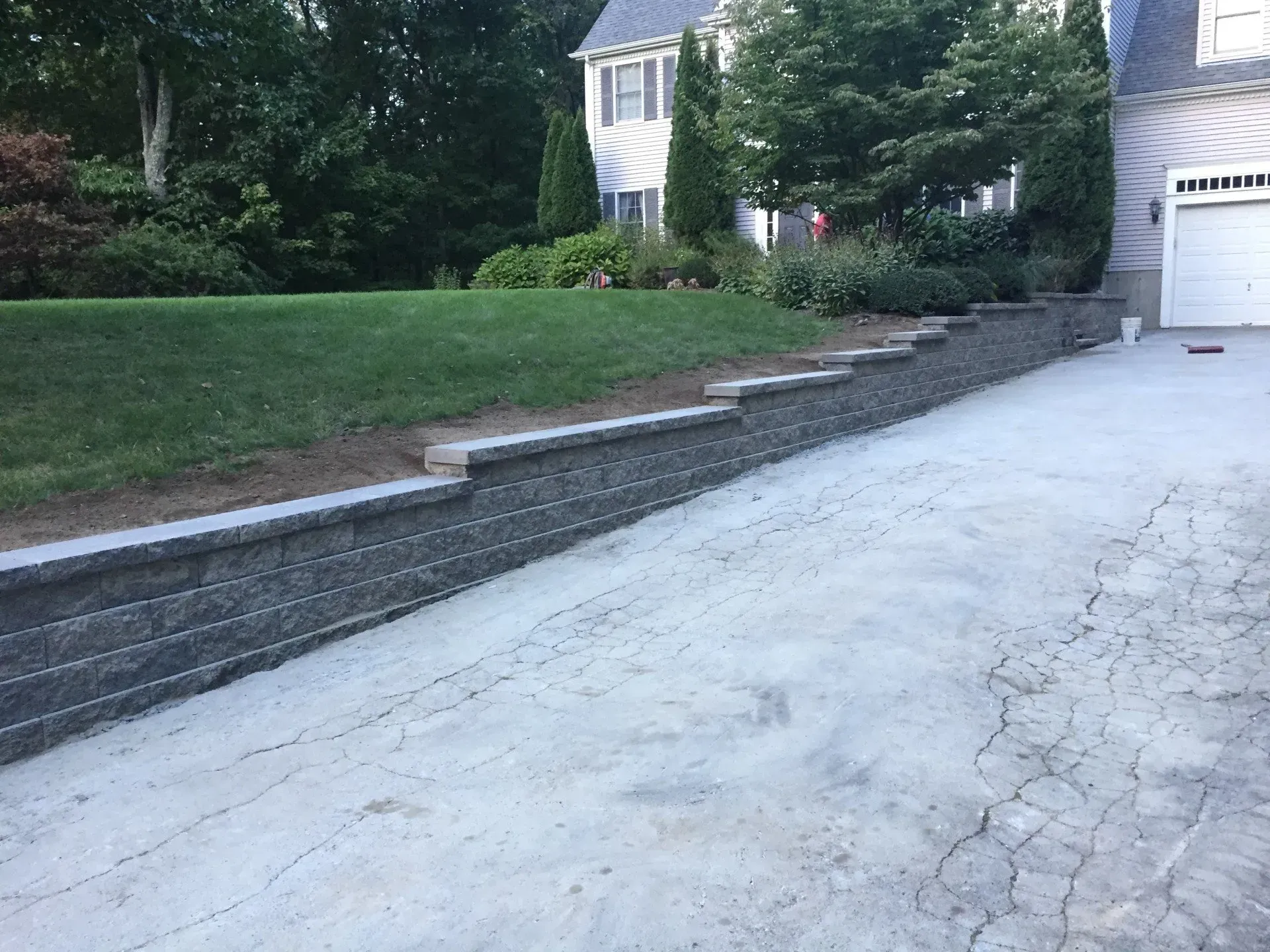 A driveway leading to a house with a garage door.