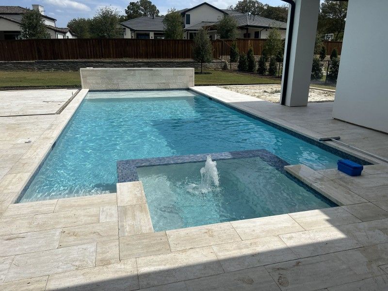 A large swimming pool with a fountain in the middle