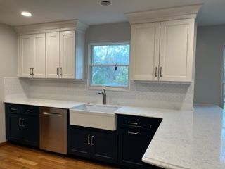 White upper cabinets and lower dark cabinets