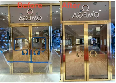 Omega store entrance before and after renovation. The gold-framed doors and sign are cleaned, with the Omega logo.