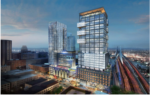 Skyscrapers at dusk, featuring a tall glass tower with illuminated balconies, near a bridge.