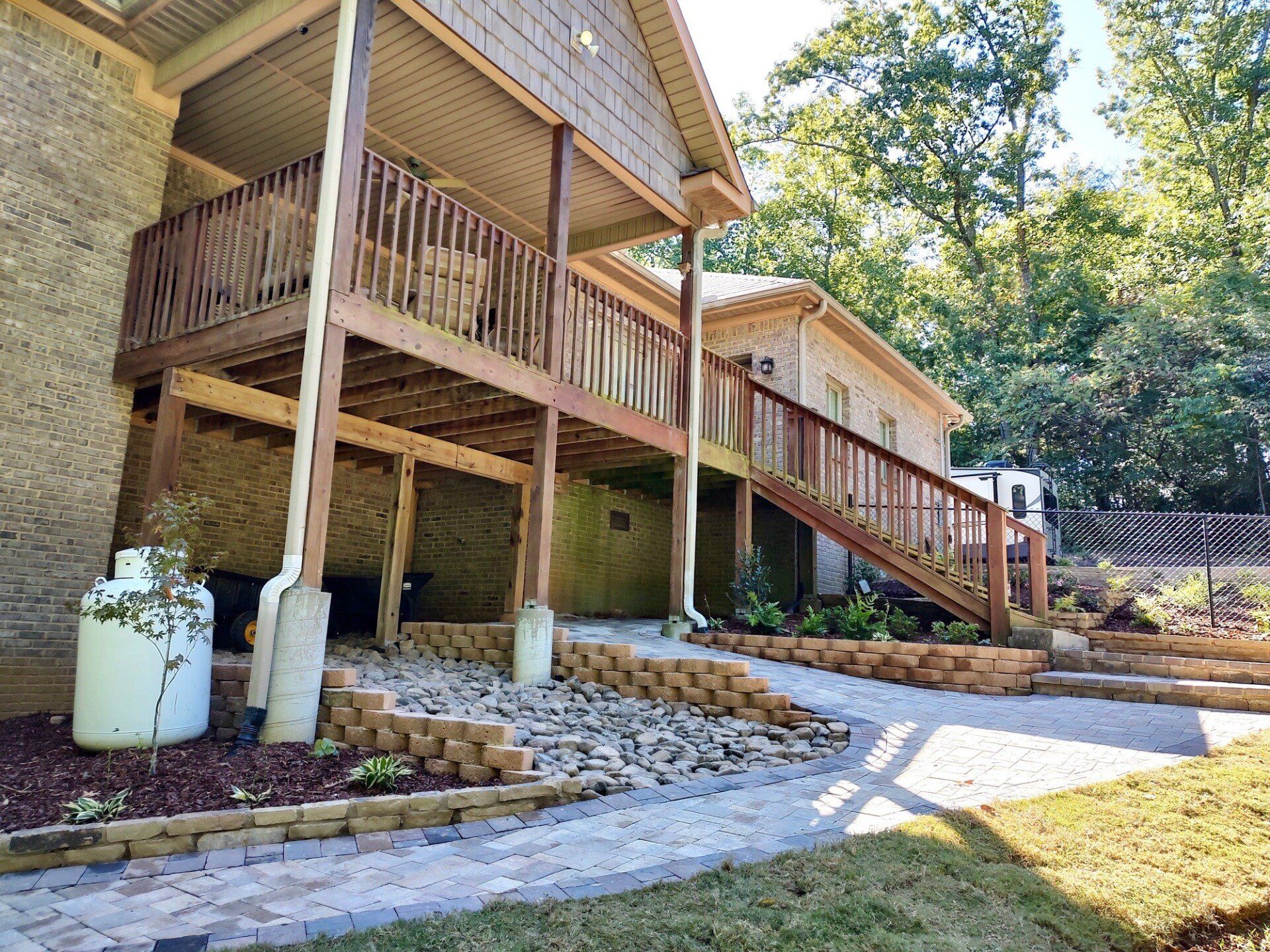 Brick house with rock landscaping and patio after