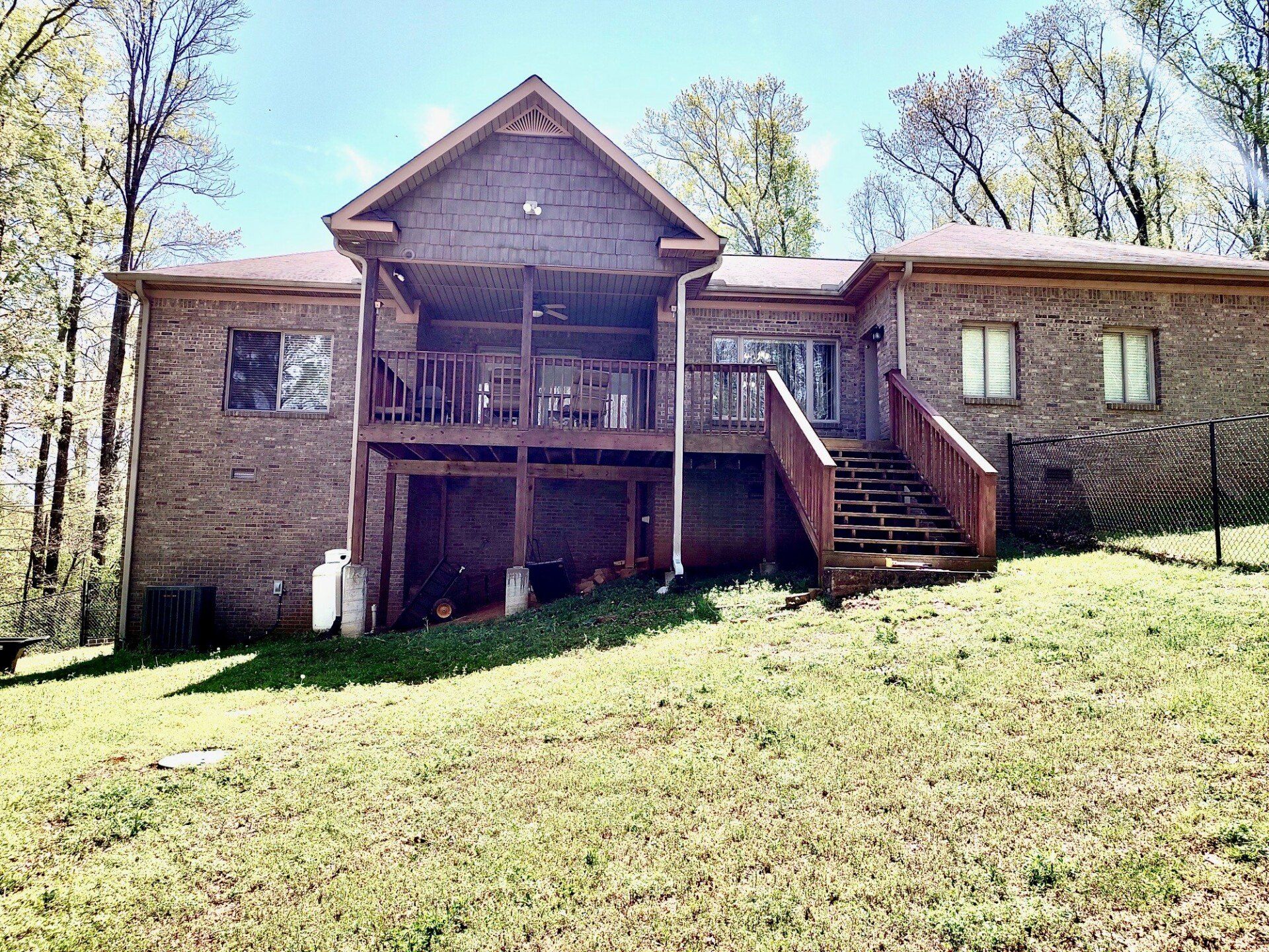 back yard of two story brick house with yard only before