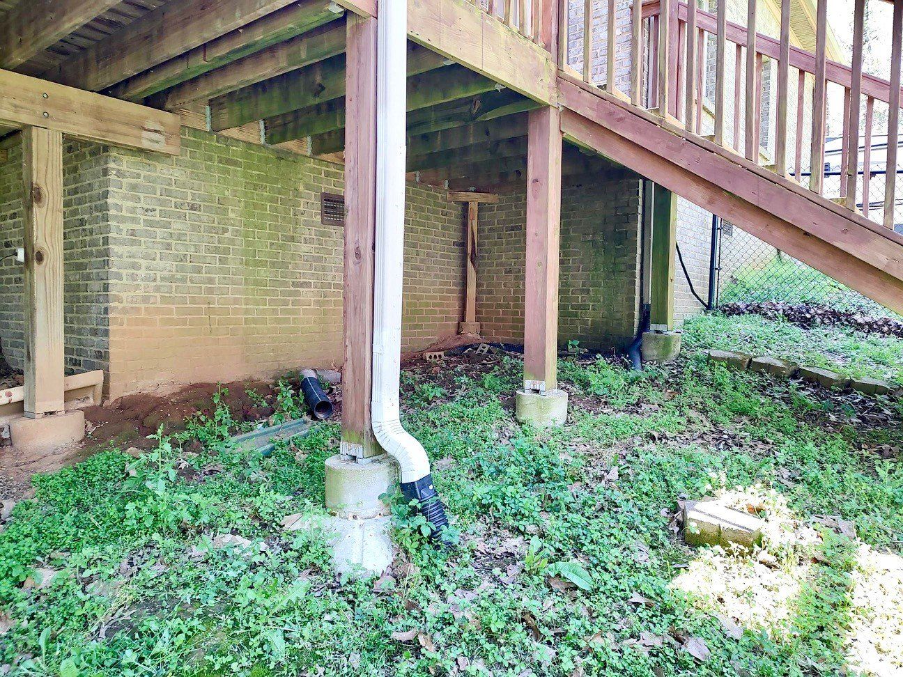 Brick house under deck yard before