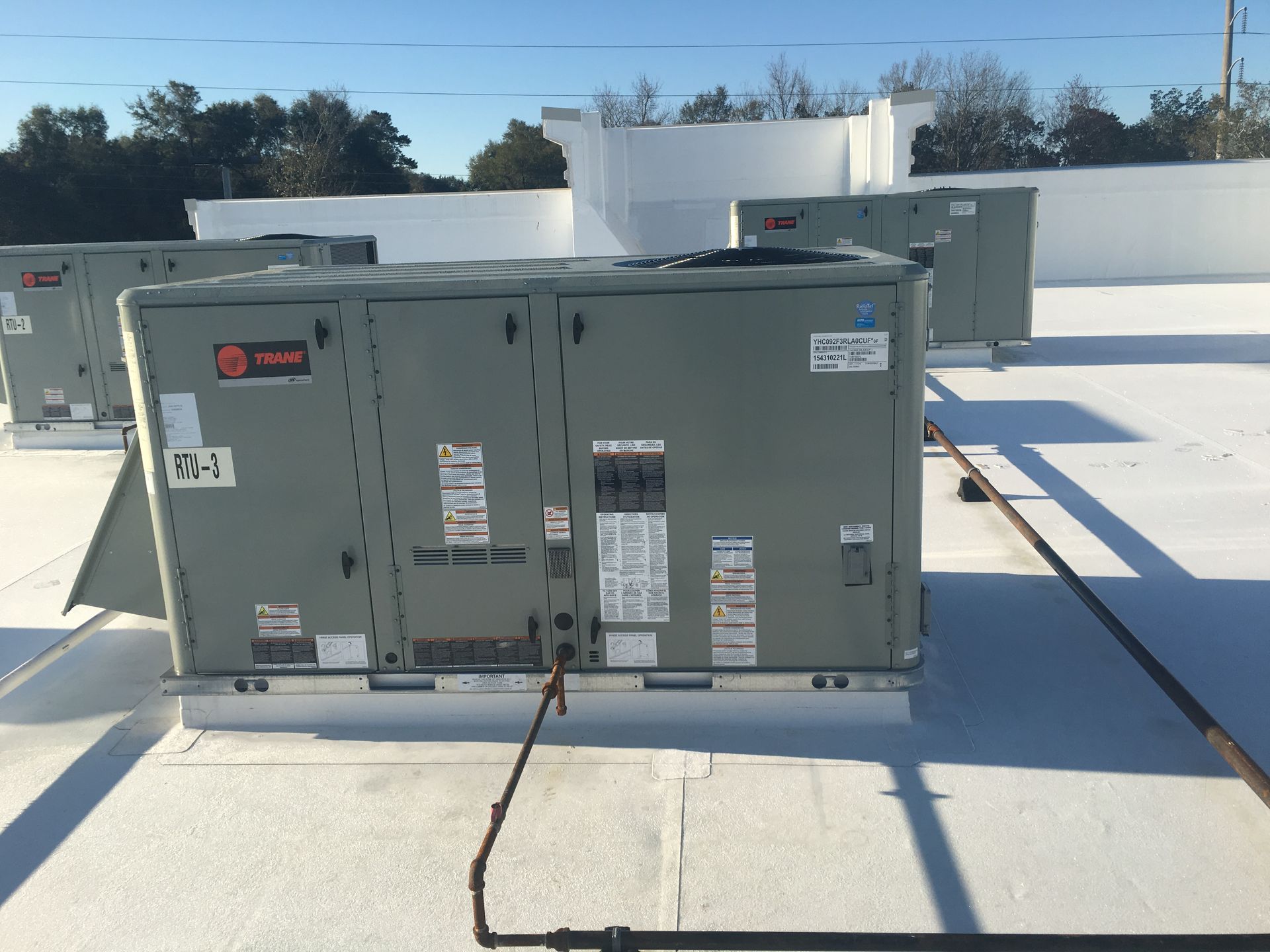 A large gray box on top of a white roof