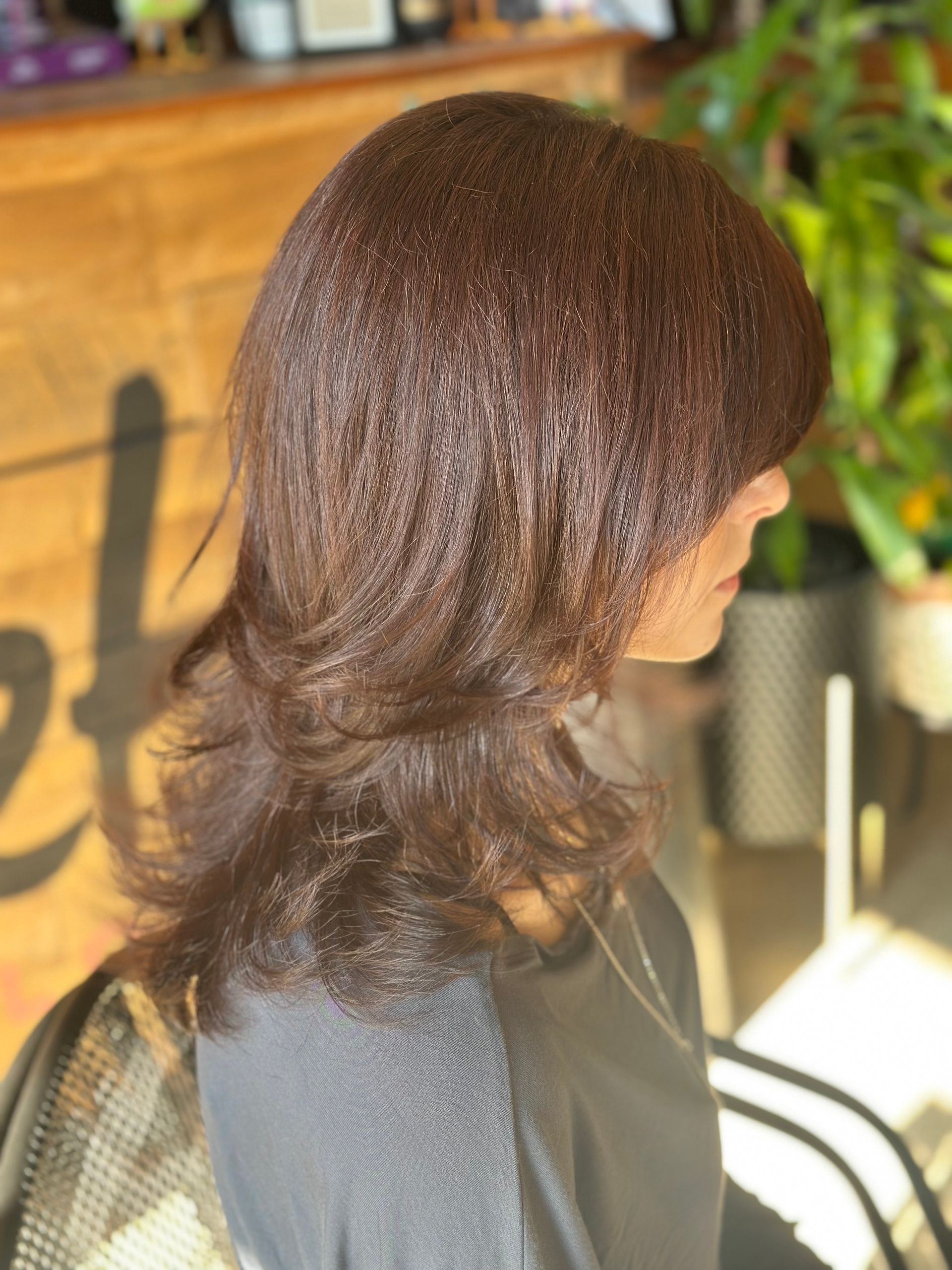 Woman with blonde, textured, short haircut, side profile; star earrings.
