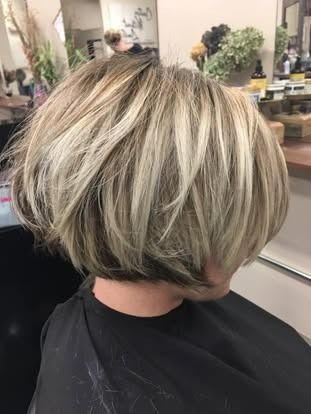 Blonde and brown layered bob hairstyle at a salon.