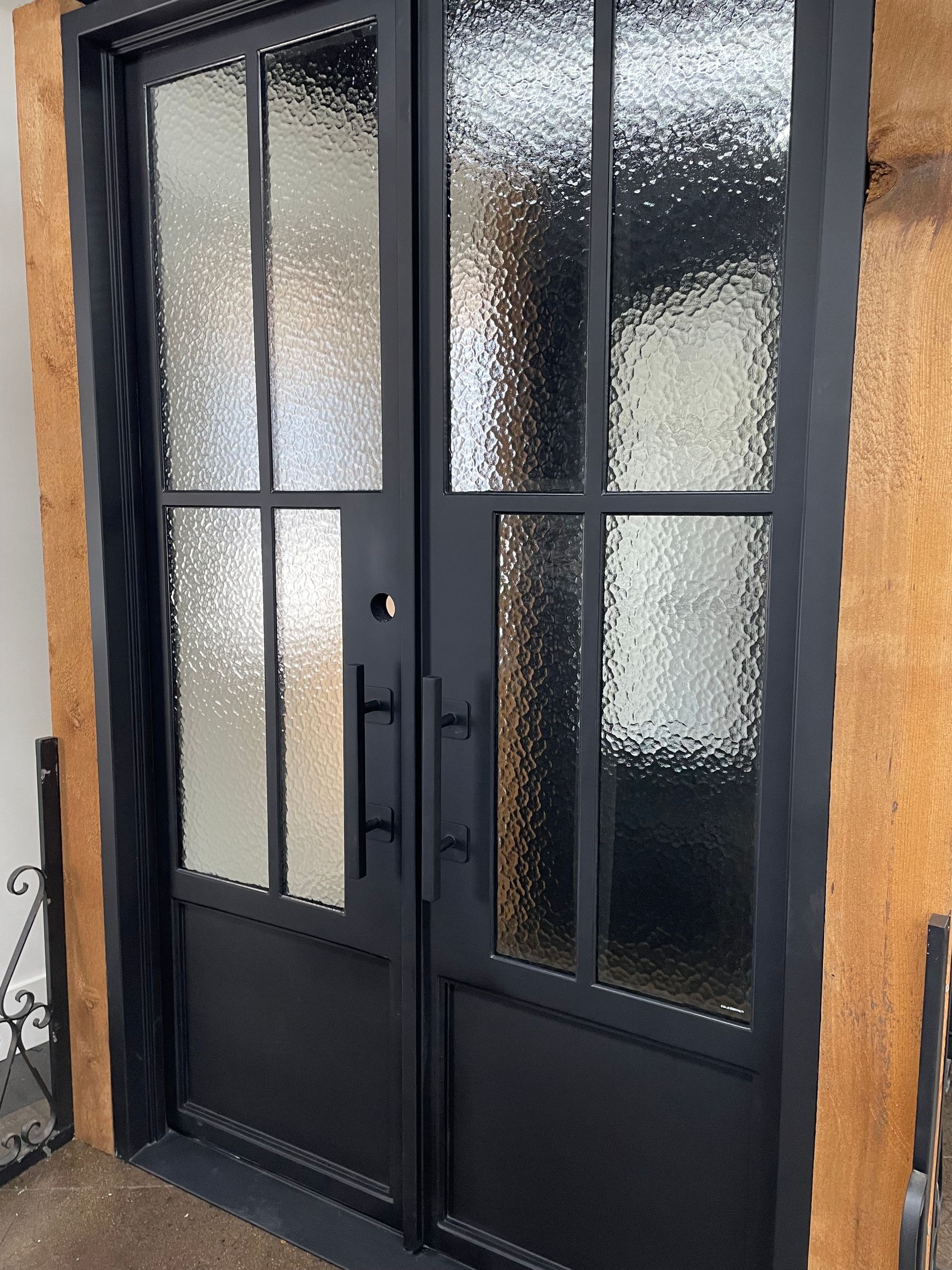A black door with a lot of glass on it