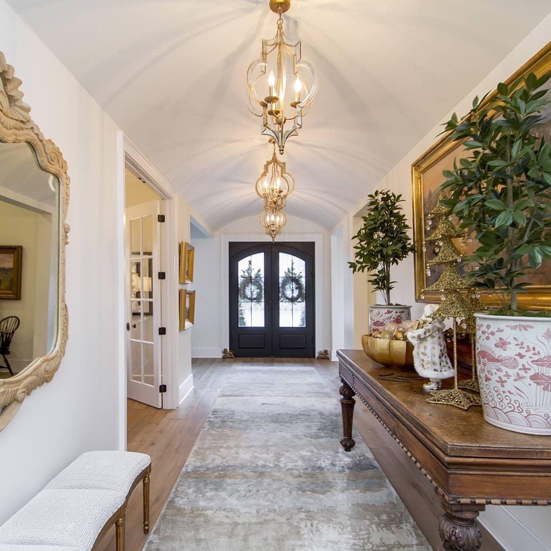A hallway with a table and a mirror