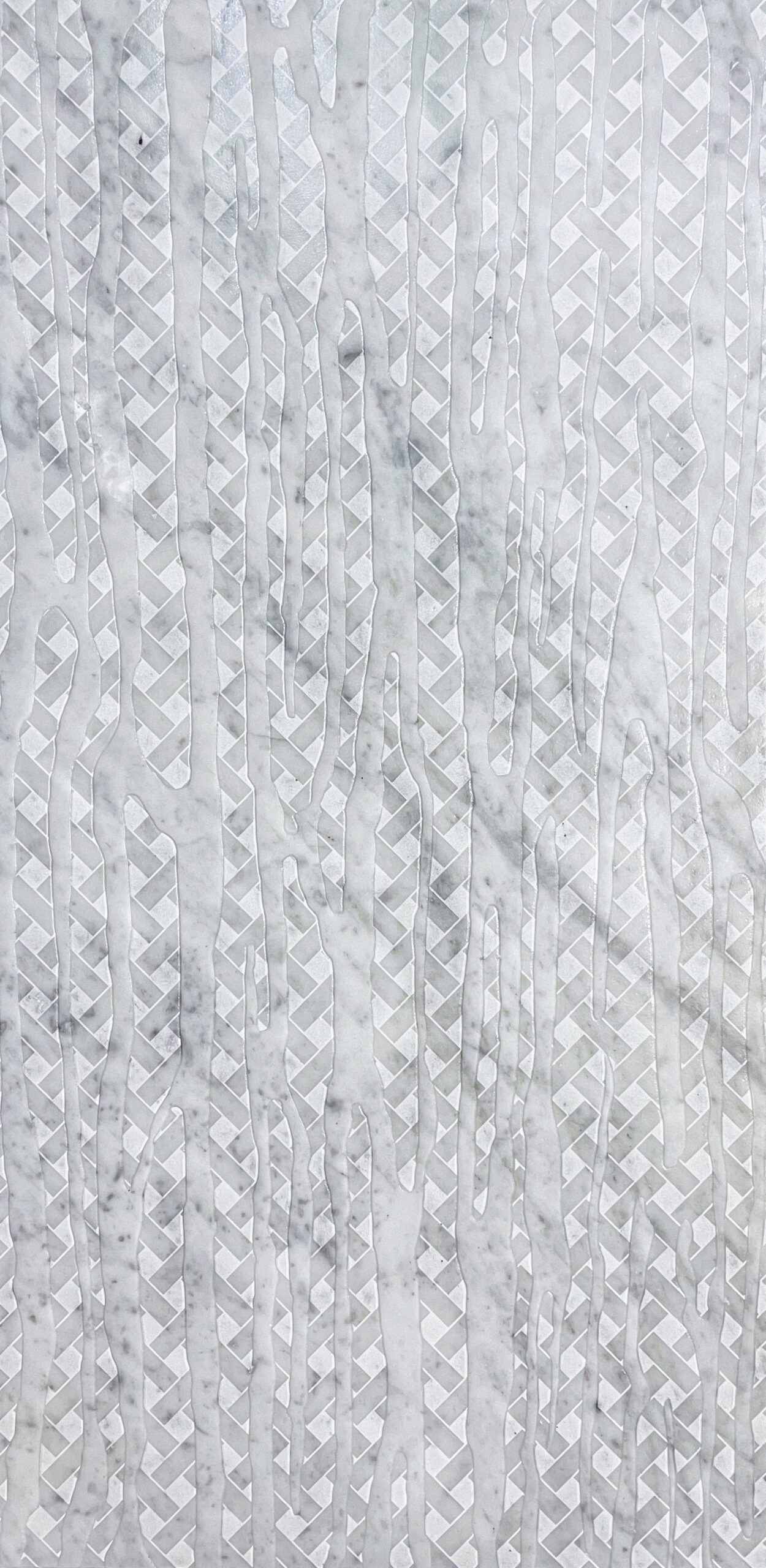 White and gray textured surface with a repeating geometric pattern of small triangles.