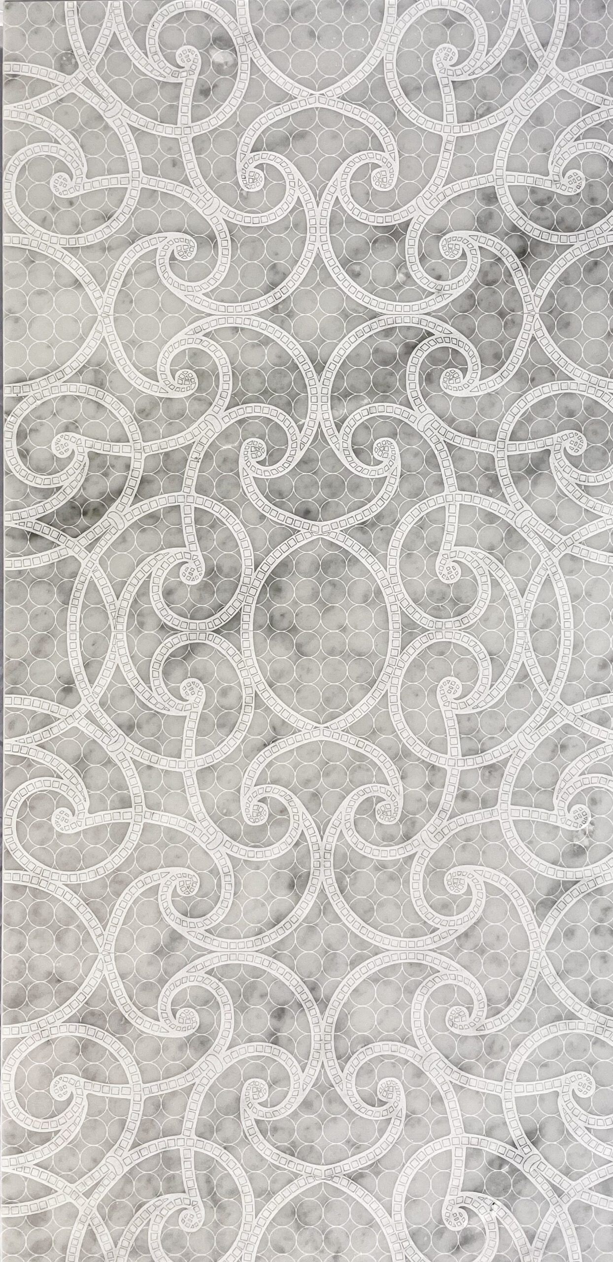 Gray marble background with white scroll-like patterns.