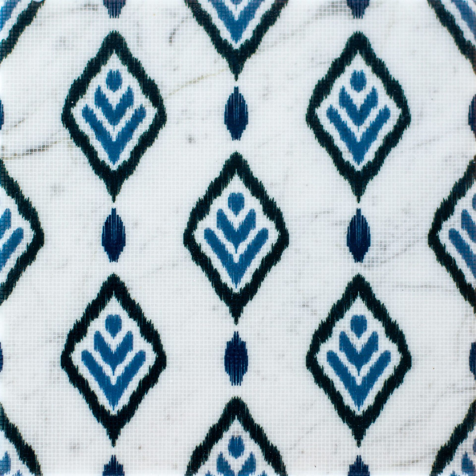 White tile with a repeating blue diamond pattern, marble background.