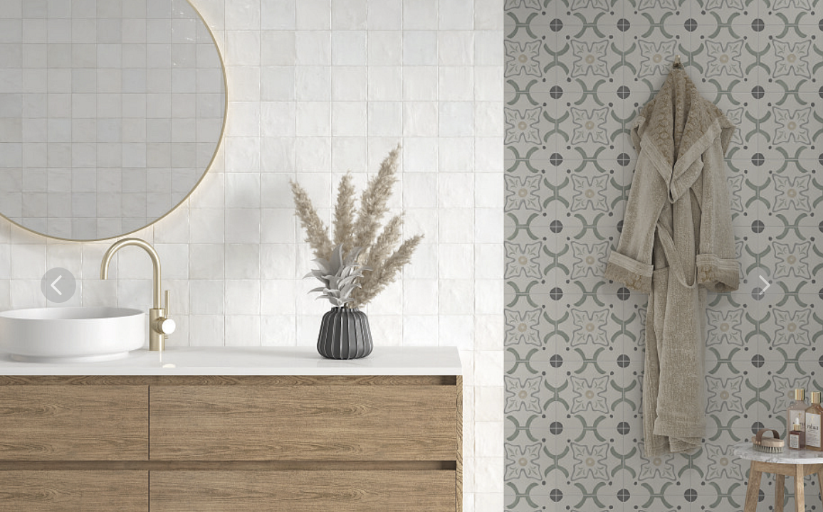Bathroom with a round mirror, wooden vanity, and a patterned accent wall.