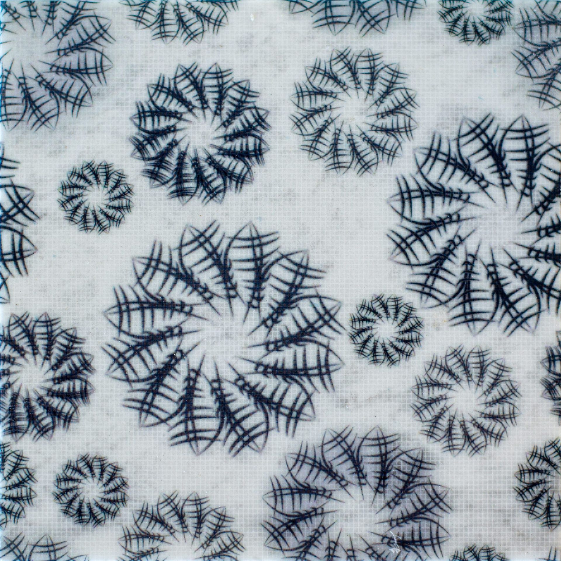White fabric with a pattern of black, spiraling floral designs of varying sizes.
