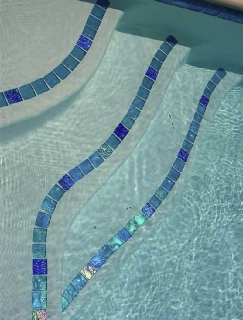 Pool steps with turquoise and blue mosaic tile trim in clear water.