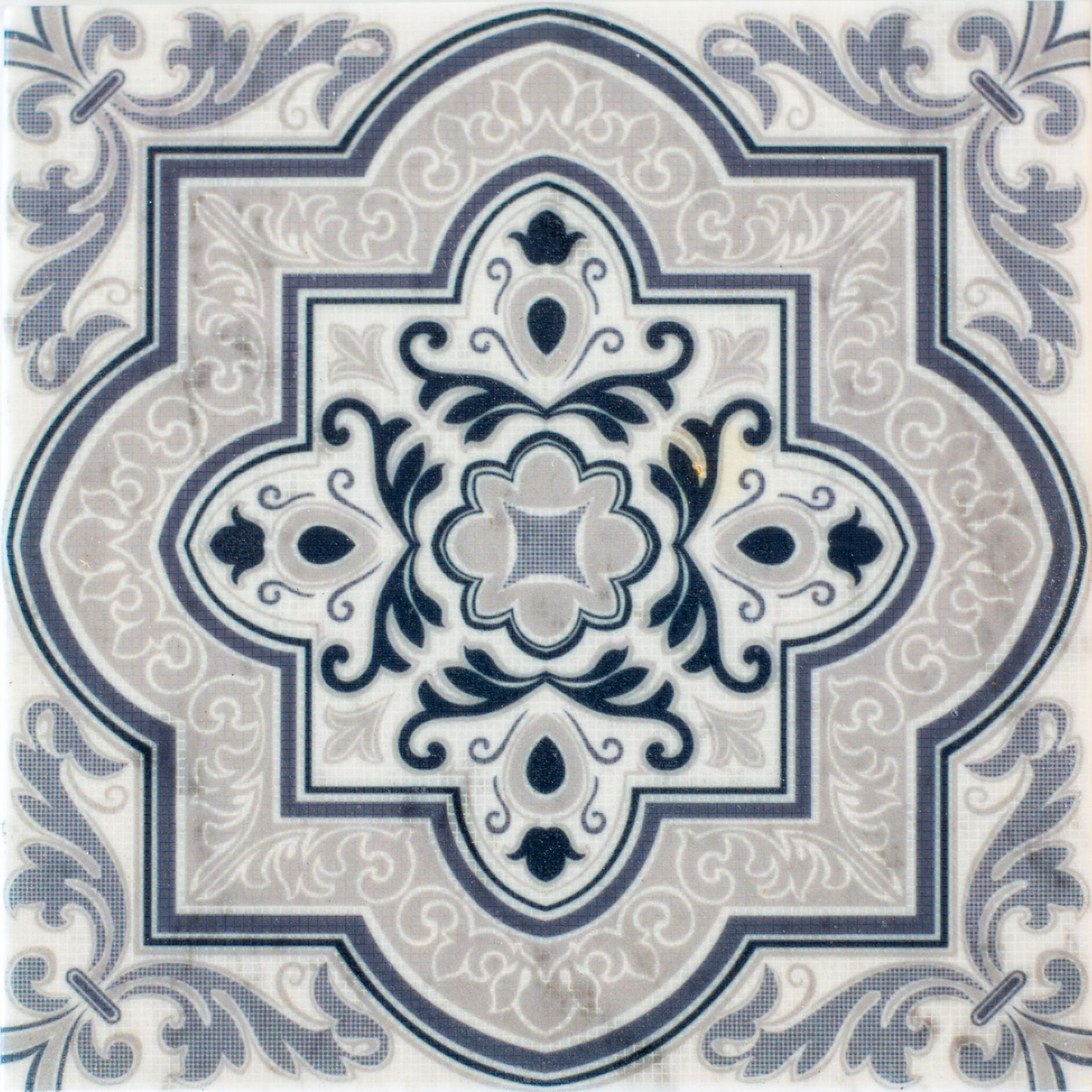 Decorative tile with a blue and gray floral pattern on a white background.