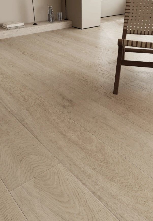 Light wood-look flooring in a room with a chair and part of a shelf unit.