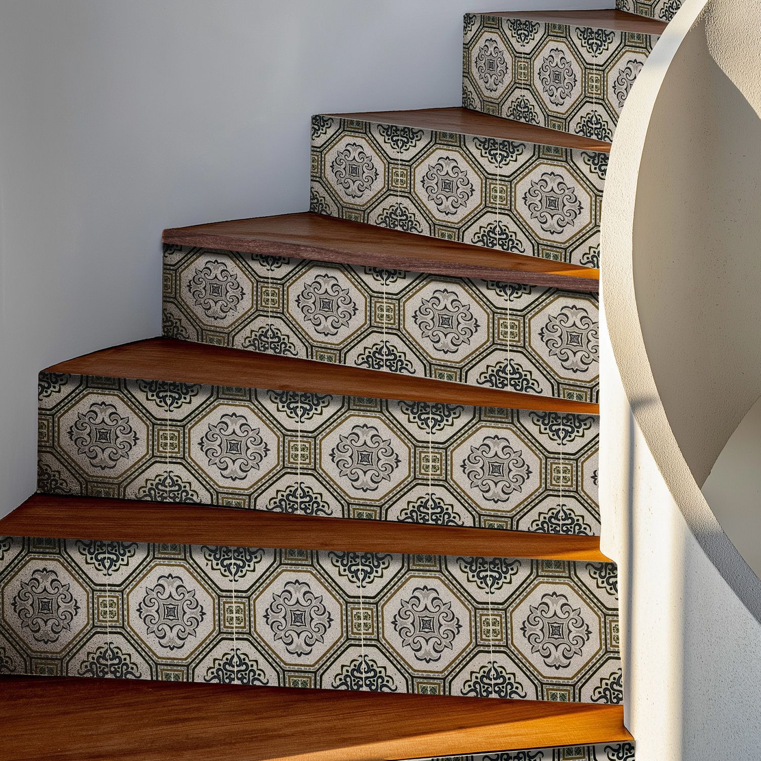 Wooden staircase with patterned tile risers and a white wall.