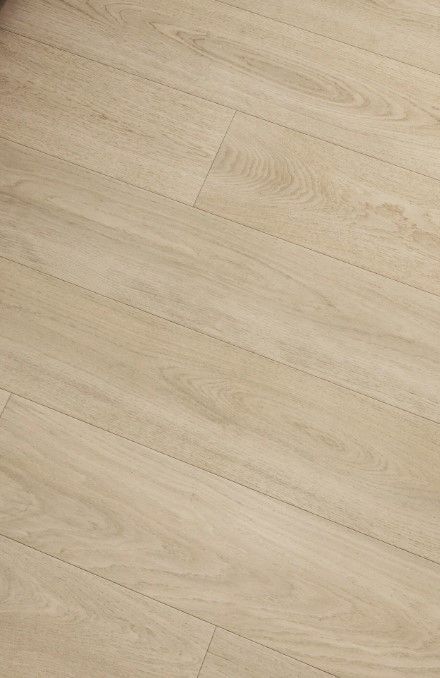 Light-colored wood floor planks, angled, with natural grain details.