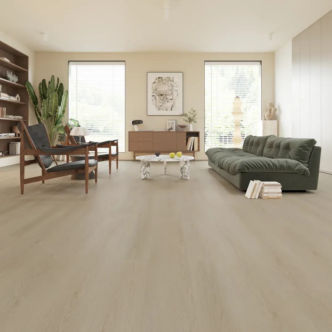 Living room with wooden floors, green couch, neutral walls, and large windows.