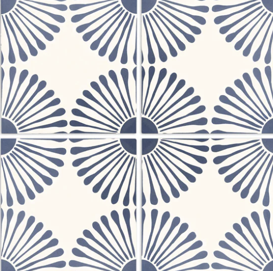 Blue and white patterned tile with sunburst design.