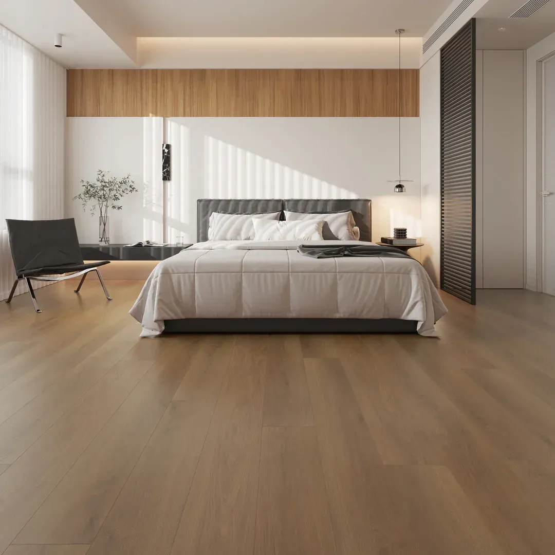 Bedroom with light wood floors, bed, chair, and wooden wall paneling.