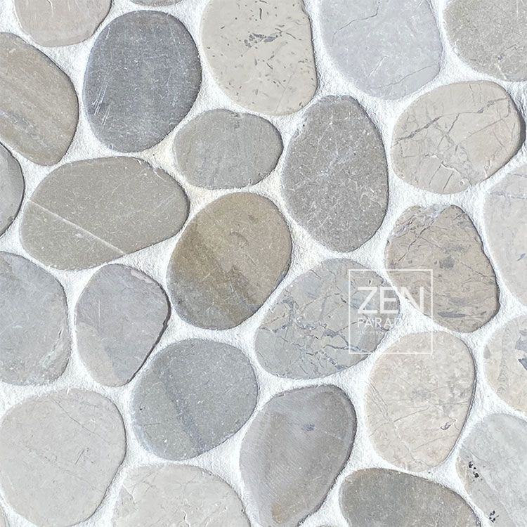 Close-up of pebble tile mosaic in shades of gray and beige.