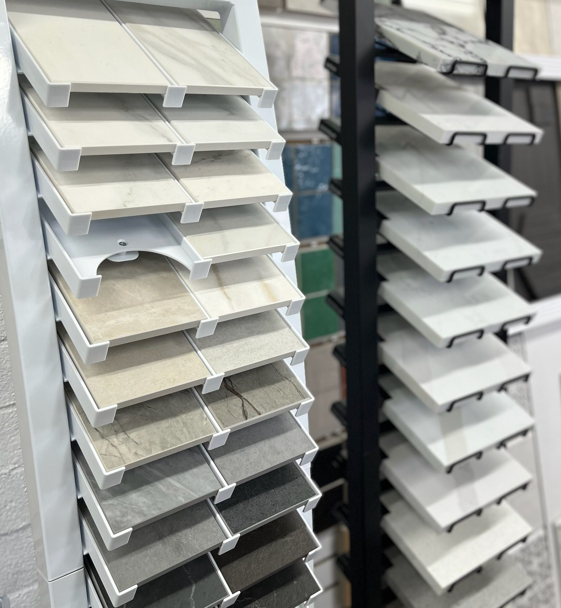 Tile samples displayed on a rotating rack, showcasing various colors and textures.