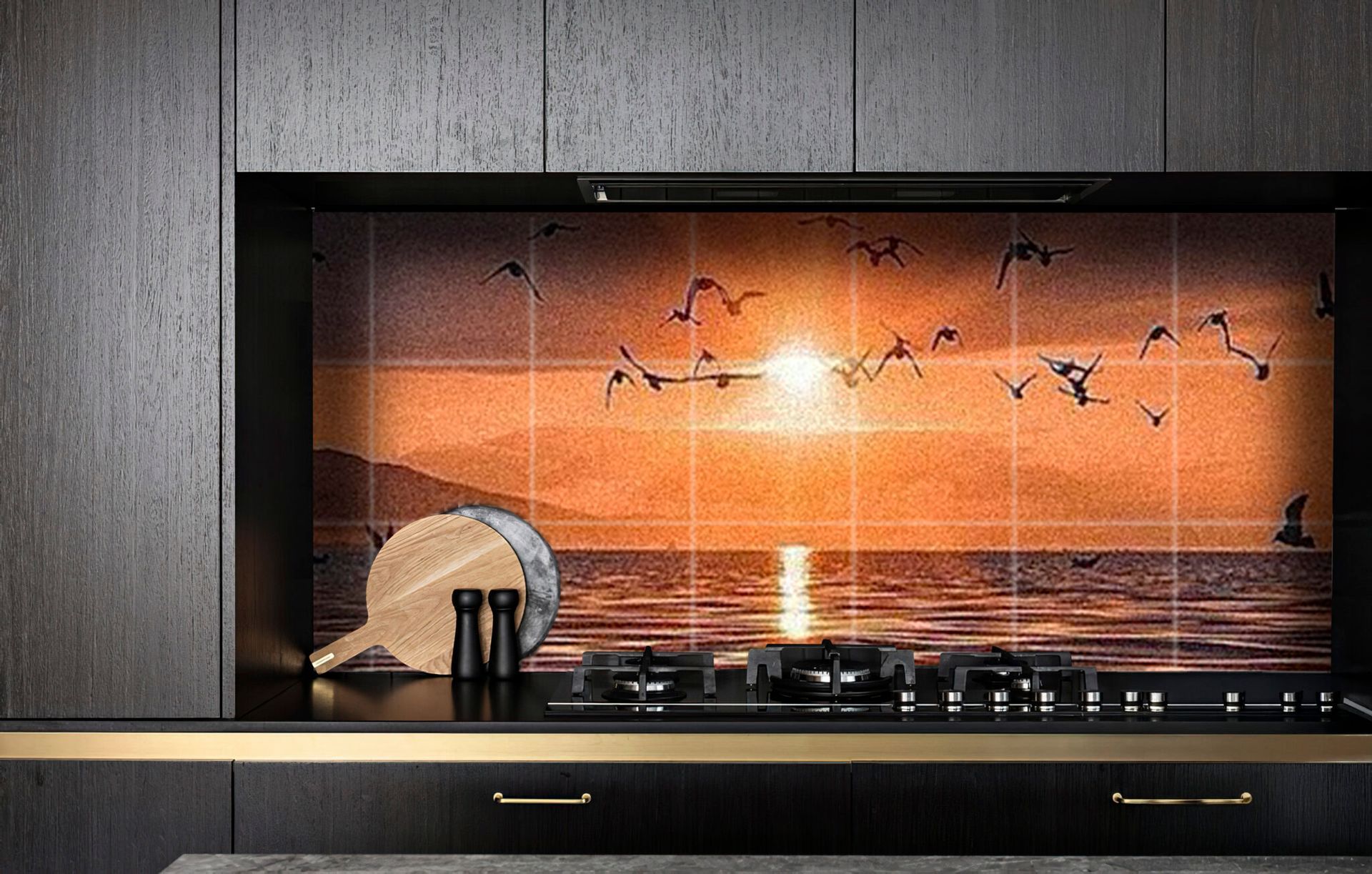 Sunset over ocean with birds flying; kitchen backsplash behind stove.