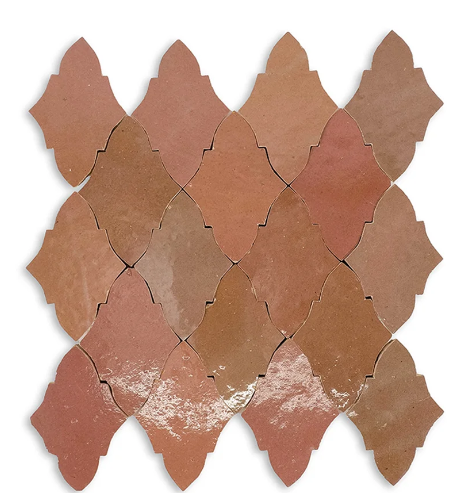 Arrangement of terracotta-colored, ornate diamond-shaped tiles with glossy finish, arranged in a pattern.