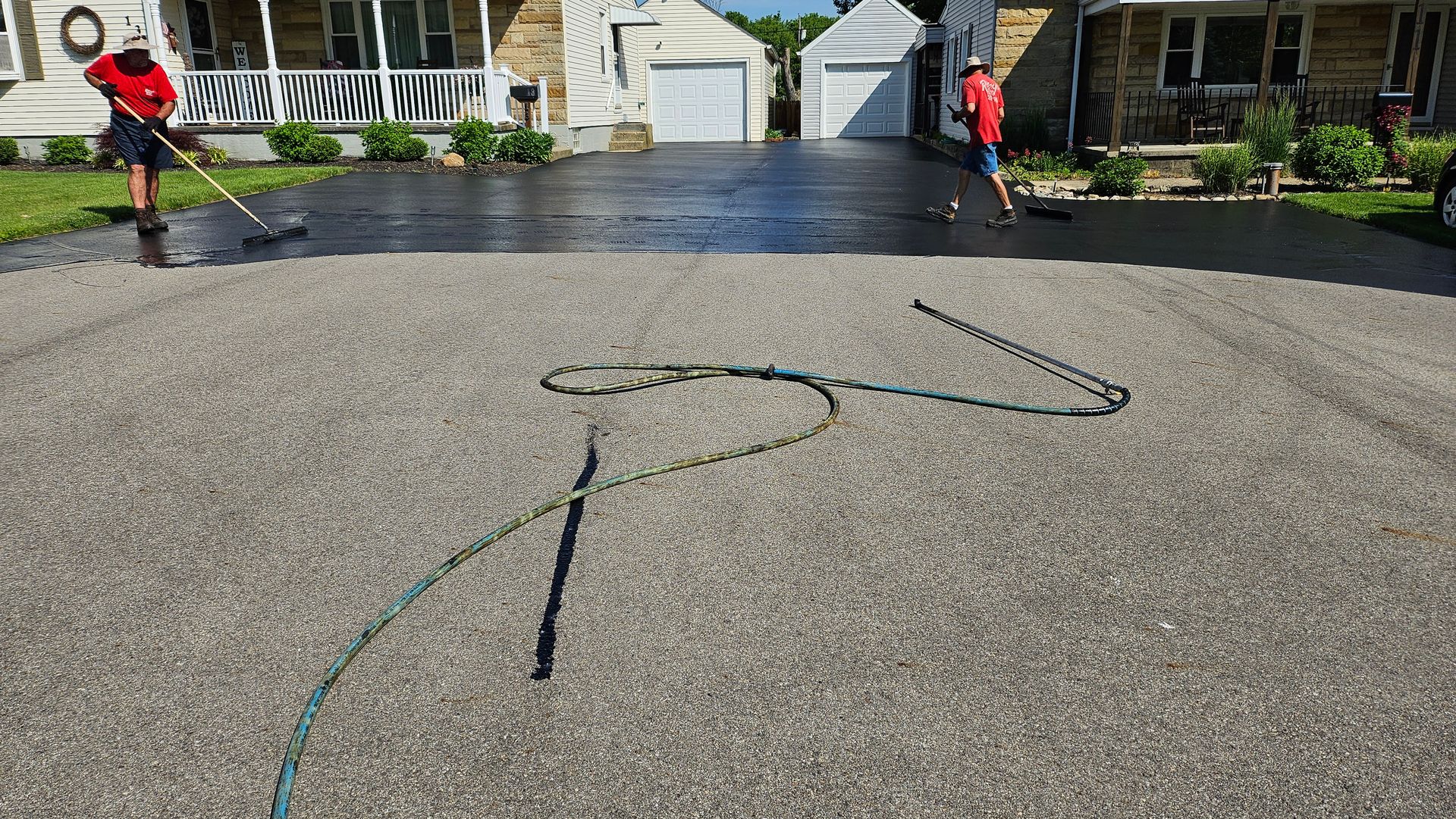 Two men working on a driveway