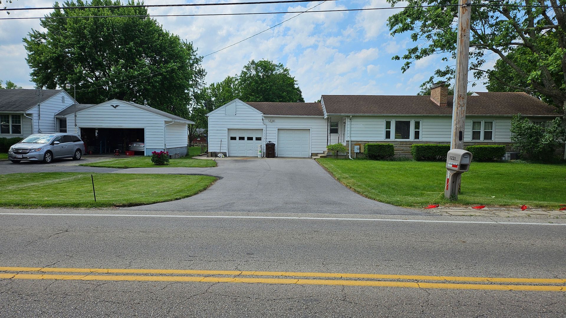 A before picture of a house with a driveway
