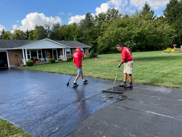 Two men sealcoating