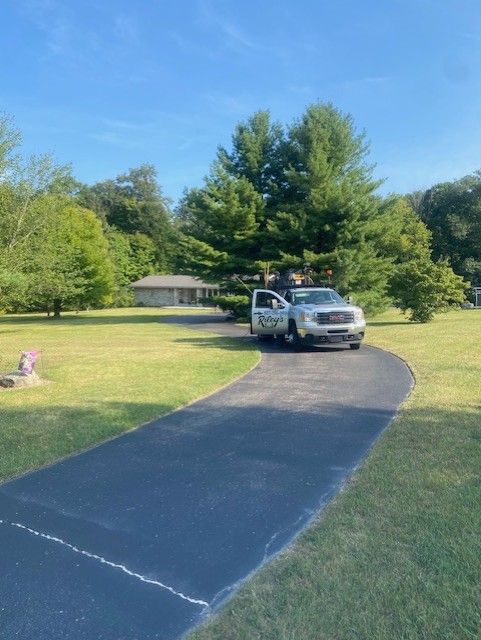 A white truck is parked in the driveway of a house.