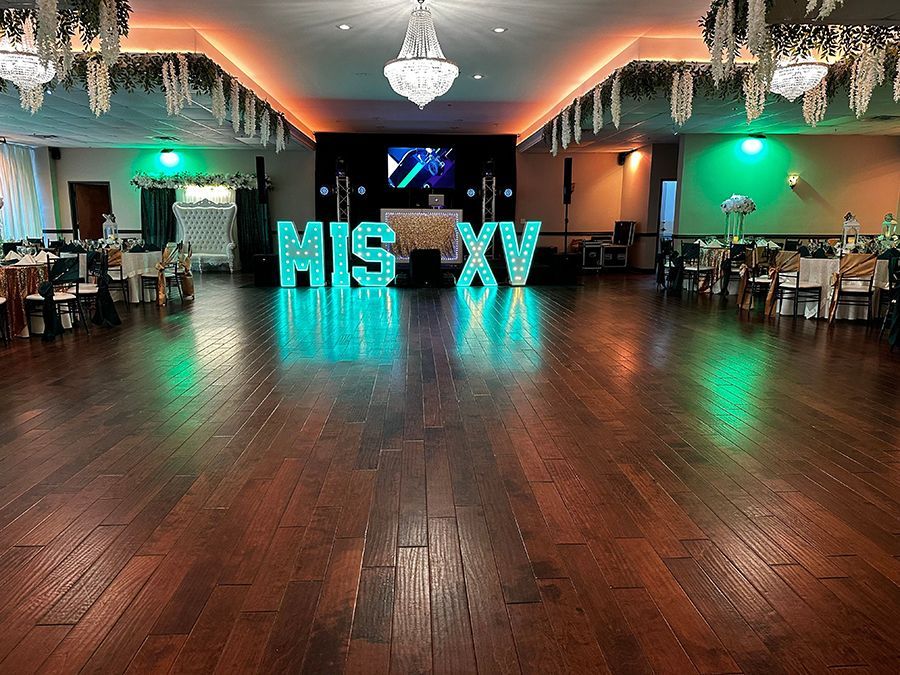 Ballroom decorated for a quinceañera with illuminated 