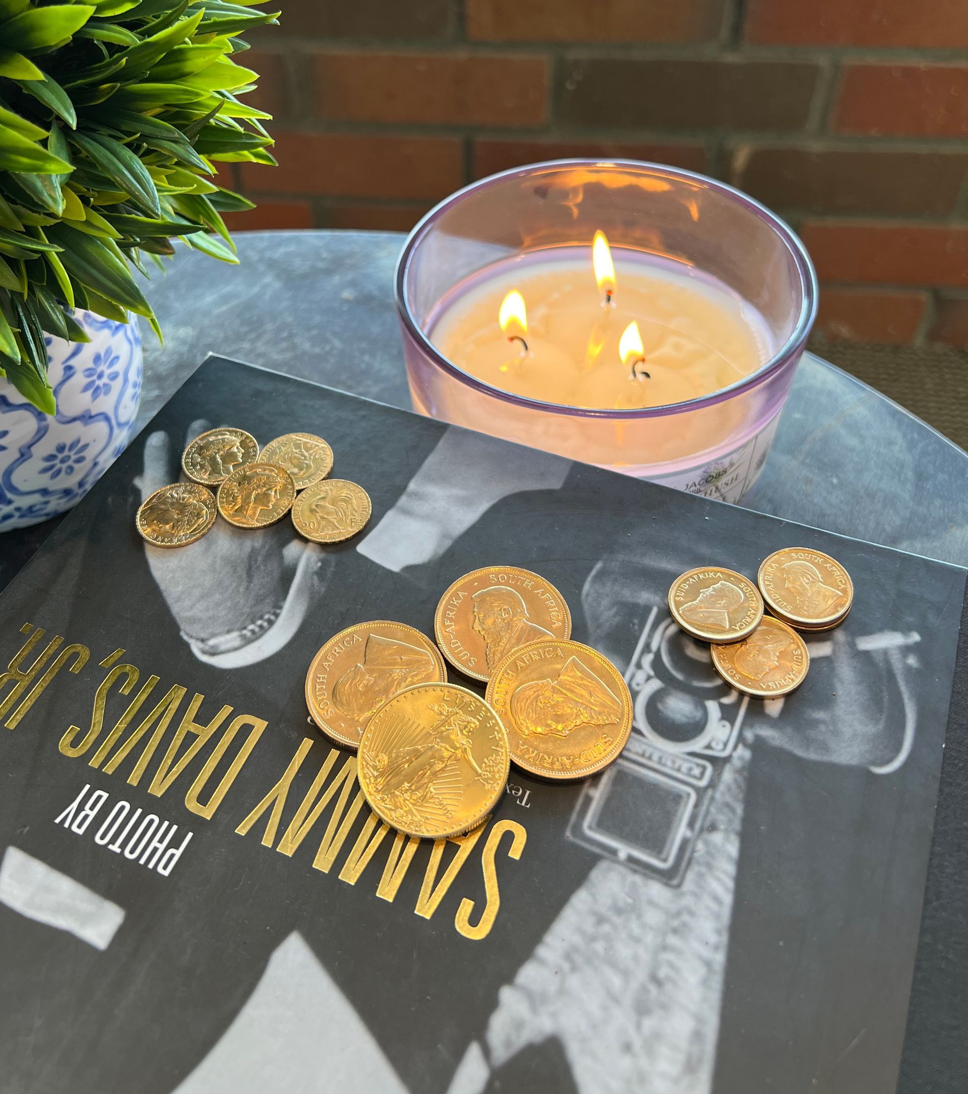 A book by samuel davis sits on a table next to a candle
