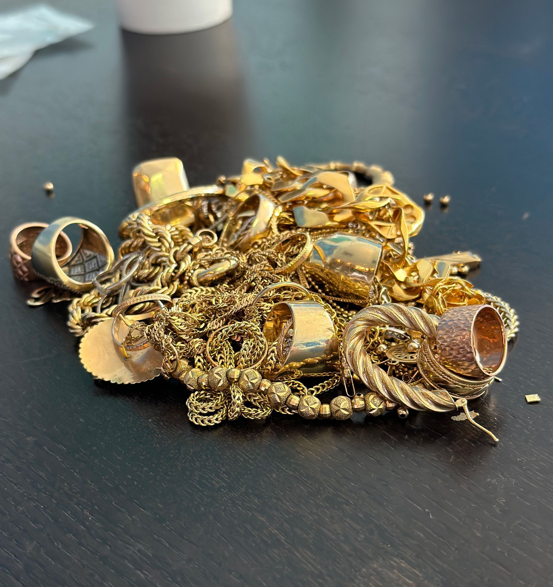 A pile of gold jewelry is on a table