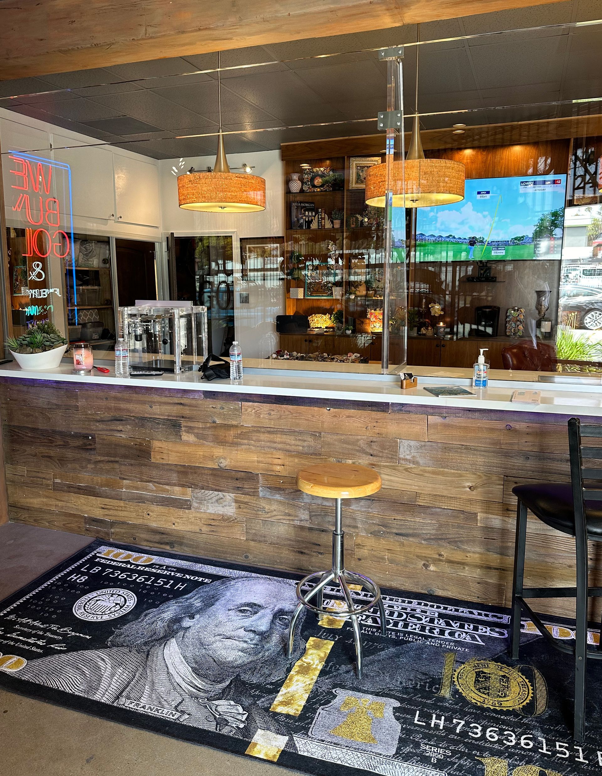 A bar with a wooden counter and a rug on the floor.