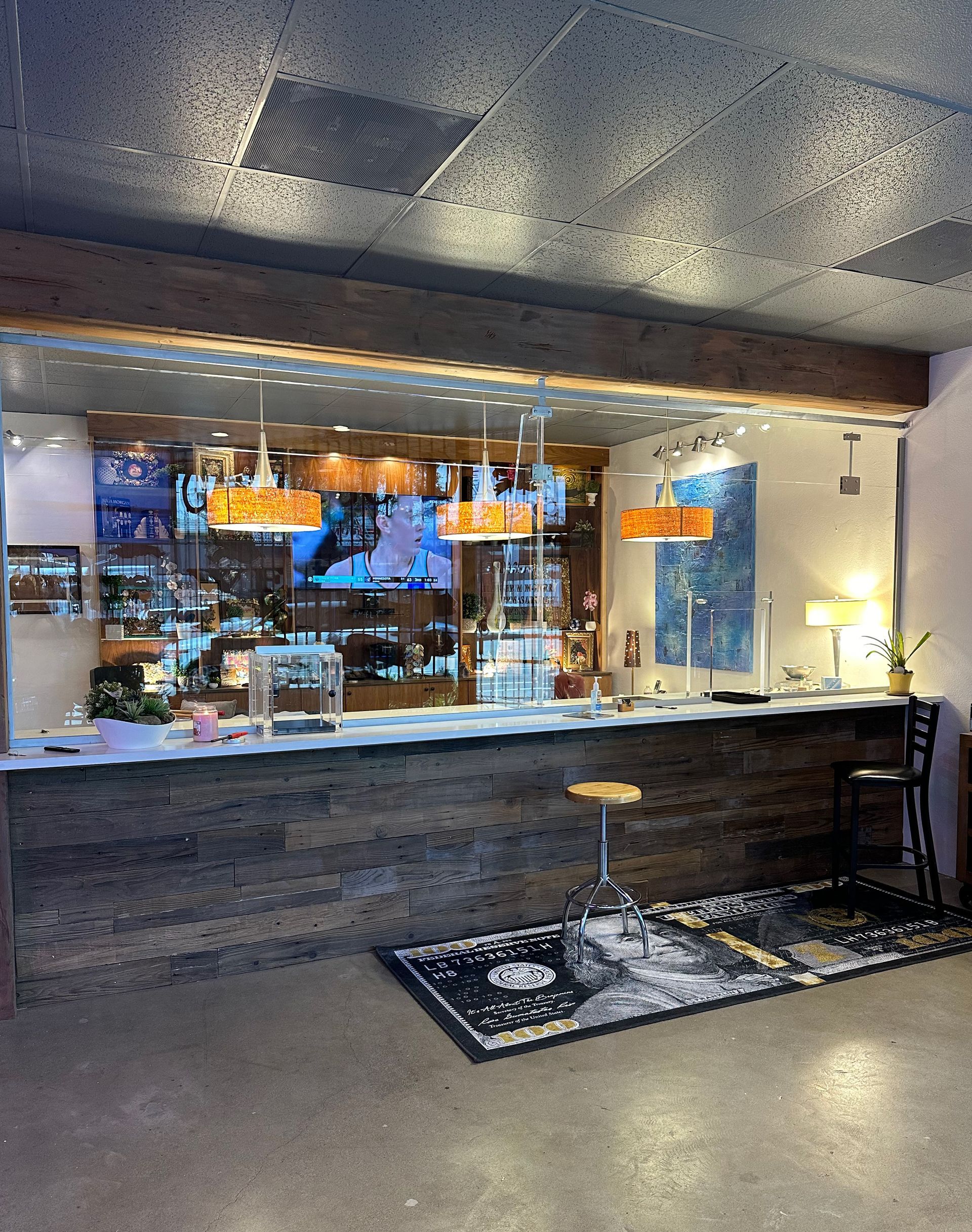 A restaurant with a long counter and a stool in front of it.