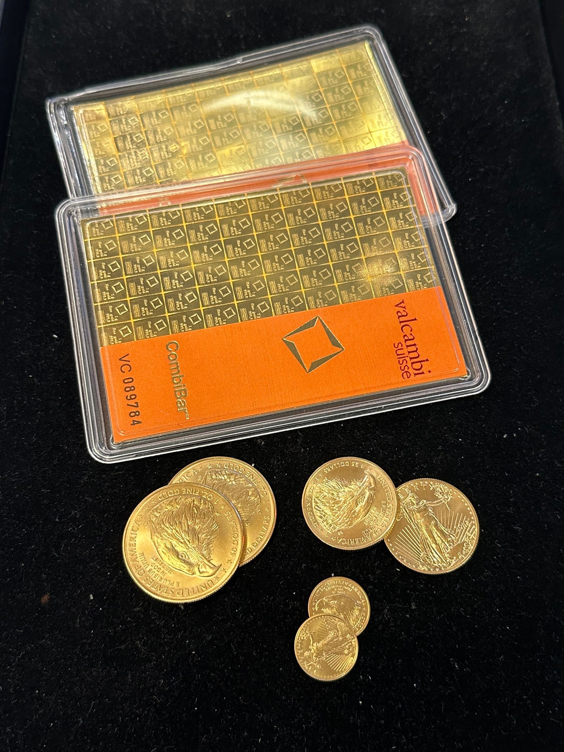 Gold coins scattered with a case holding a gold rectangular item. Black background.