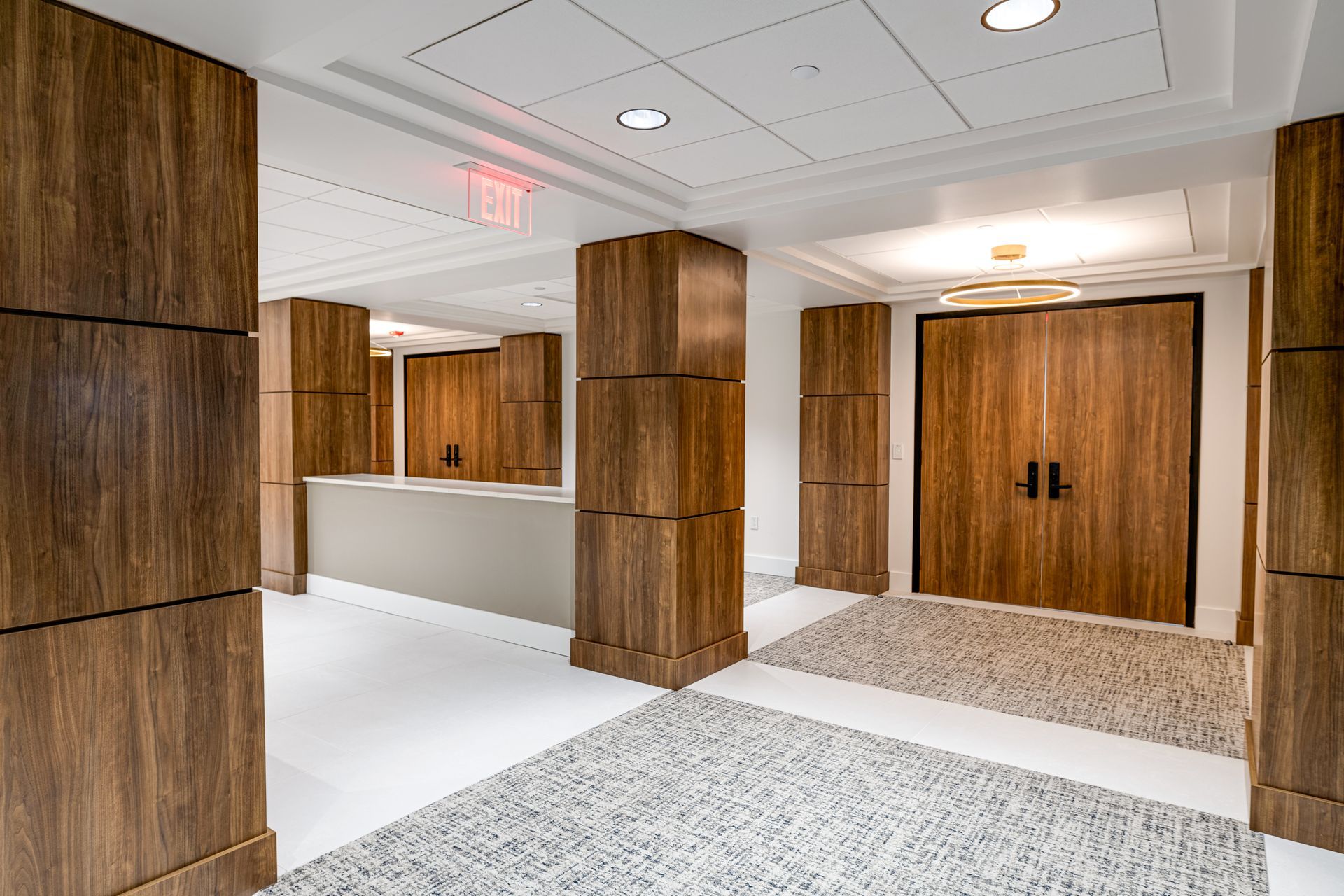 A hallway with wooden columns and doors in a building.