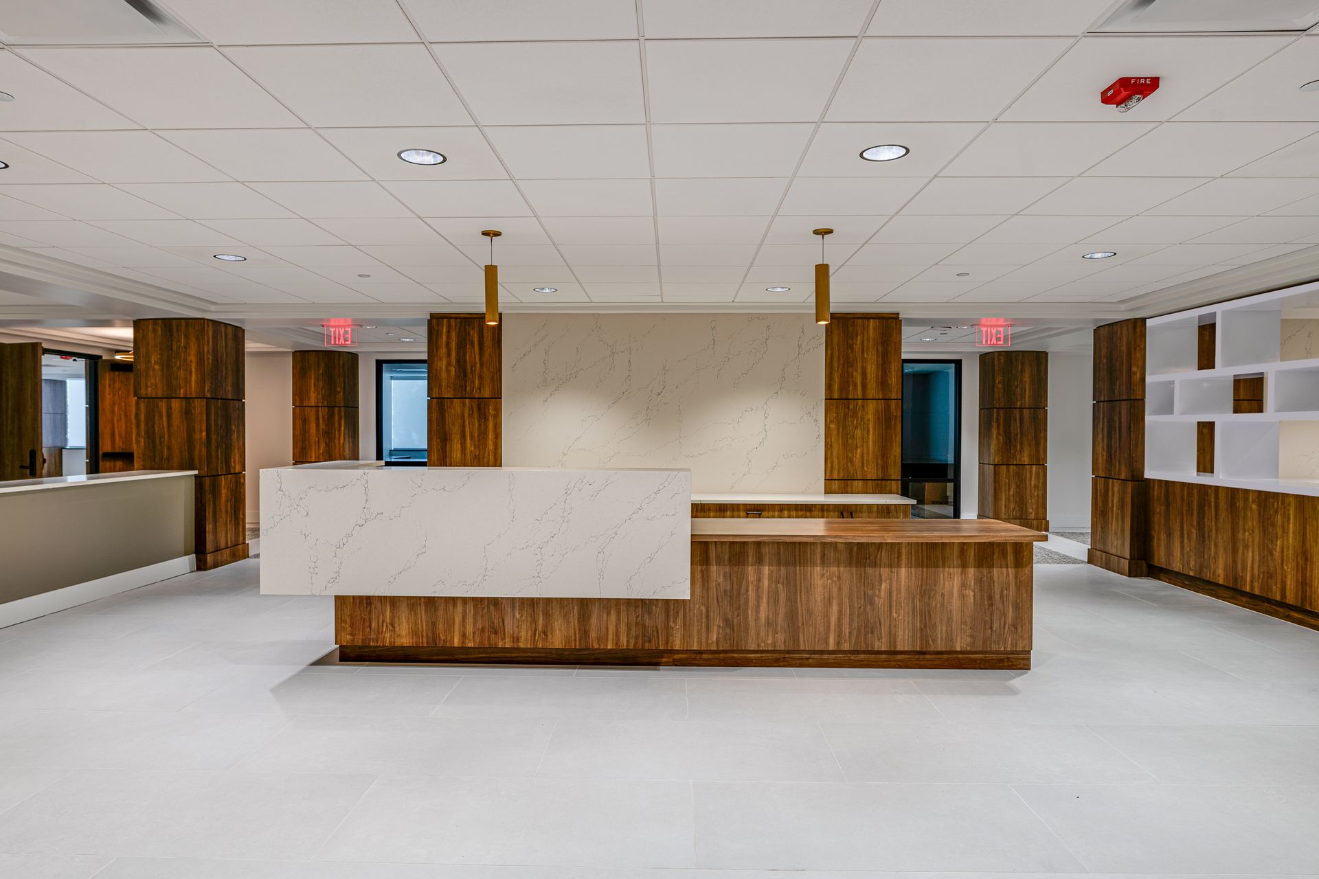 A large empty room with a white counter and wooden walls.