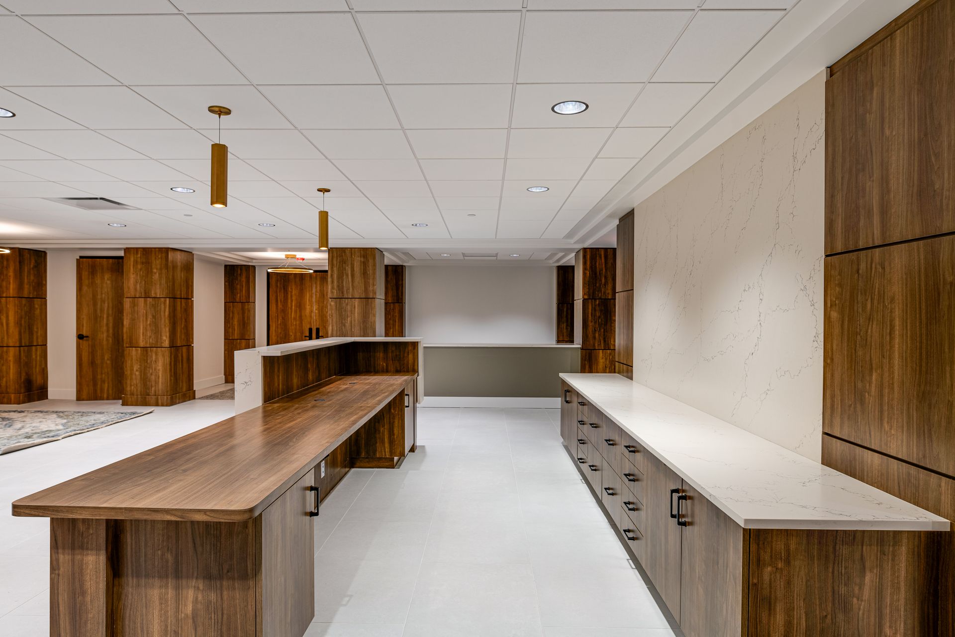 There is a long wooden counter in the middle of the room.