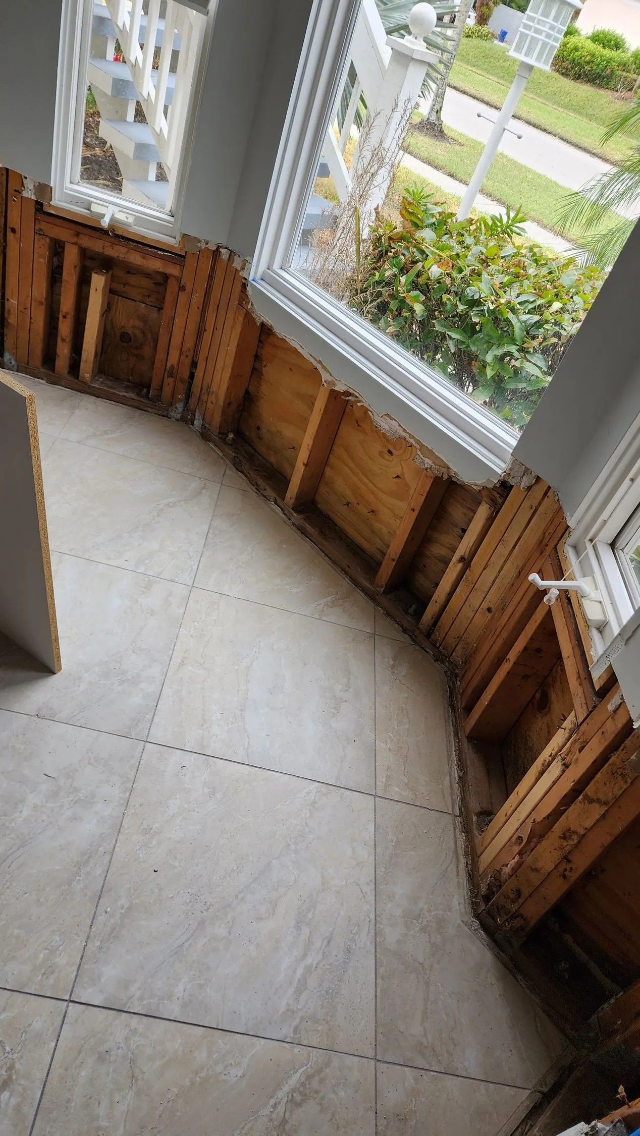 Interior view showing exposed curved wood framing around a window.