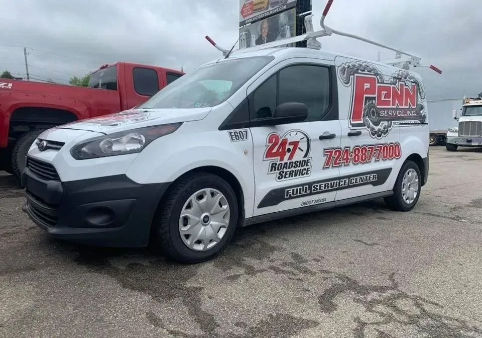 White Penn Aire Inc. van with logo and phone number, parked outdoors.